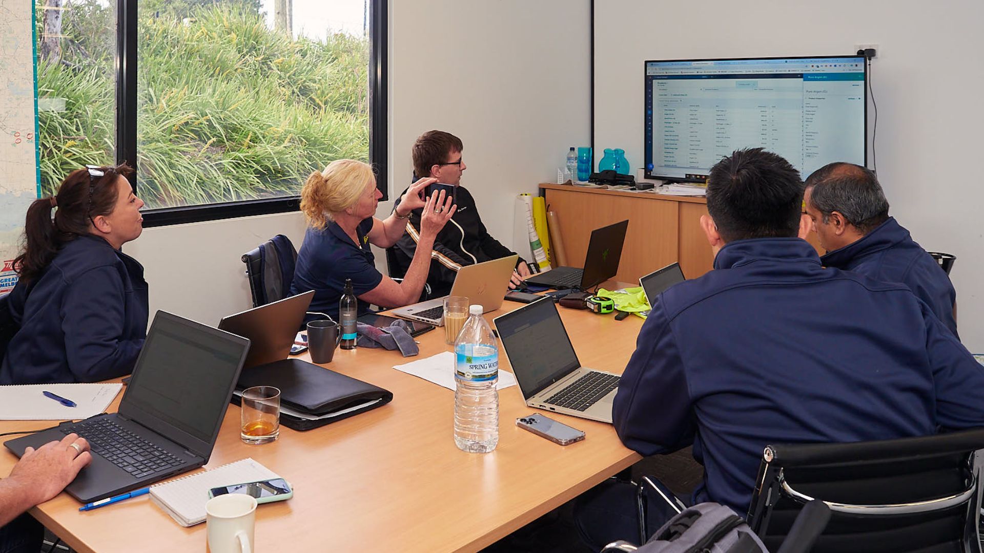 A team reviewing their sales system together on screen